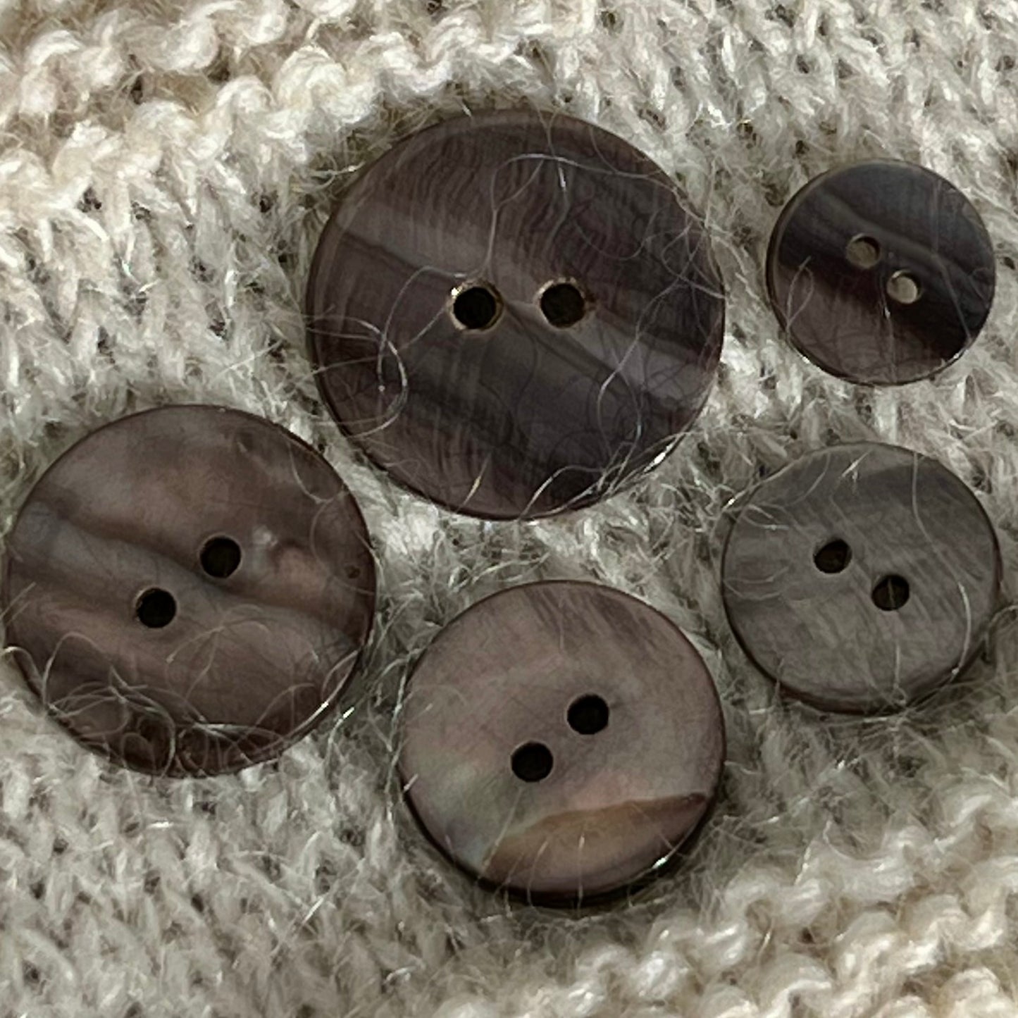 Solid perlemorsknap i en varm grå brun farve.